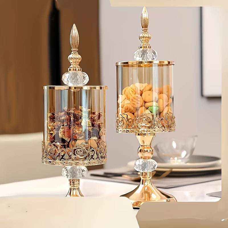 Decorative glass candle holders with gold accents on a table.