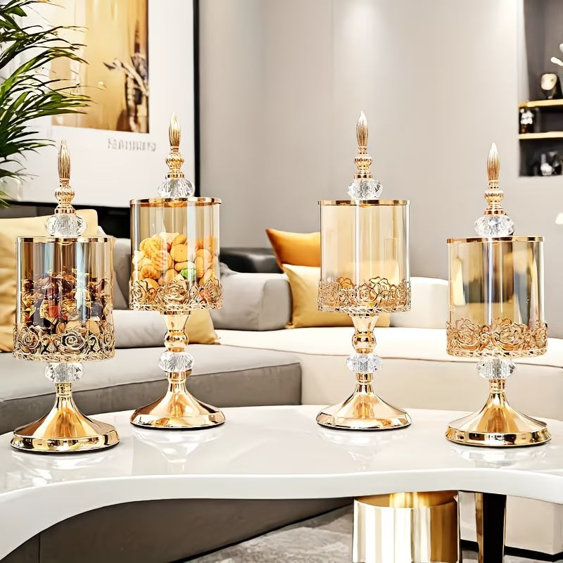 Set of four gold candle holders on a table in a living room setting.