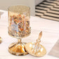 Decorative glassware with gold accents on a white surface