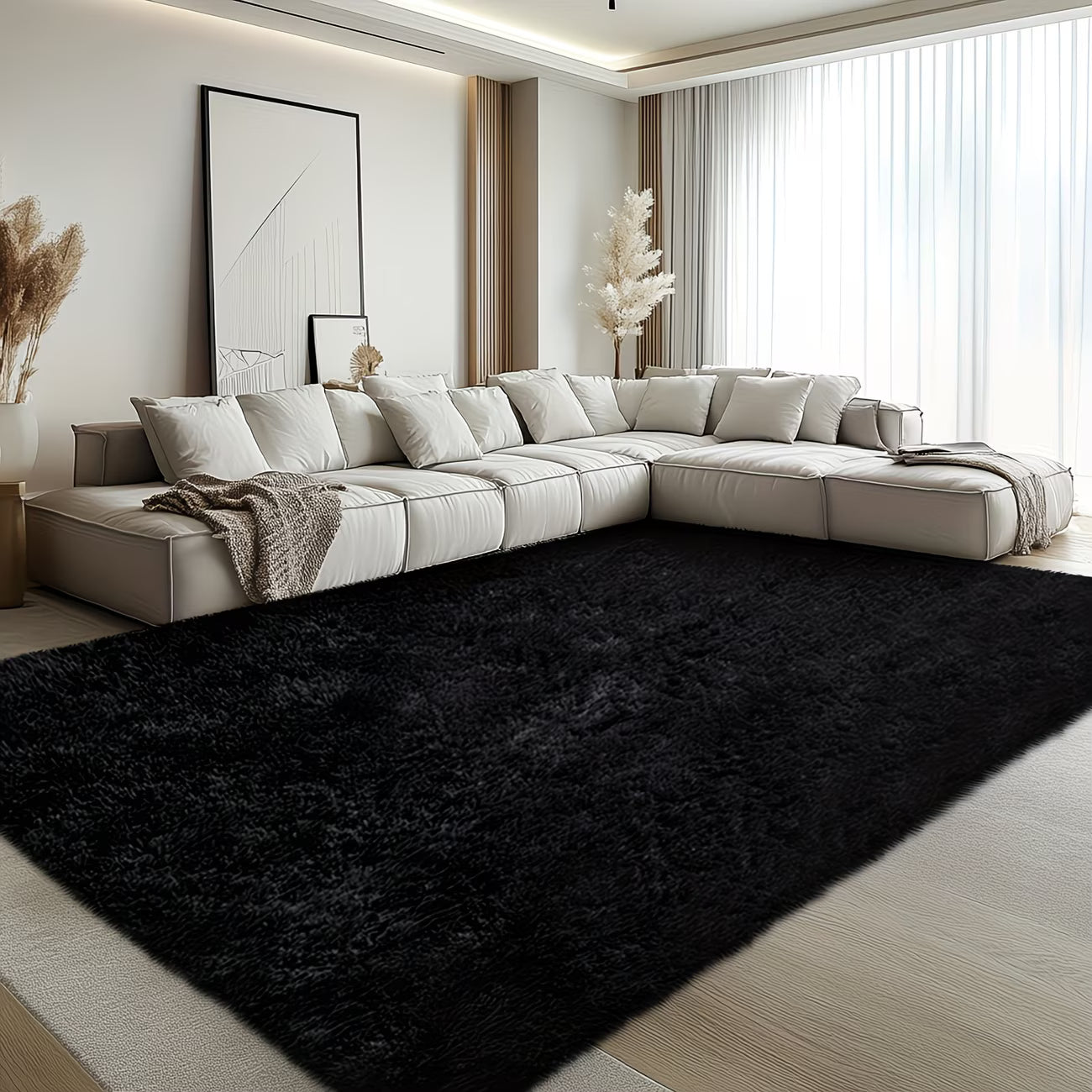 Modern living room with a large sectional sofa and a black rug.