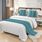 Bedroom with a bed featuring white bedding and blue decorative pillows and throw.