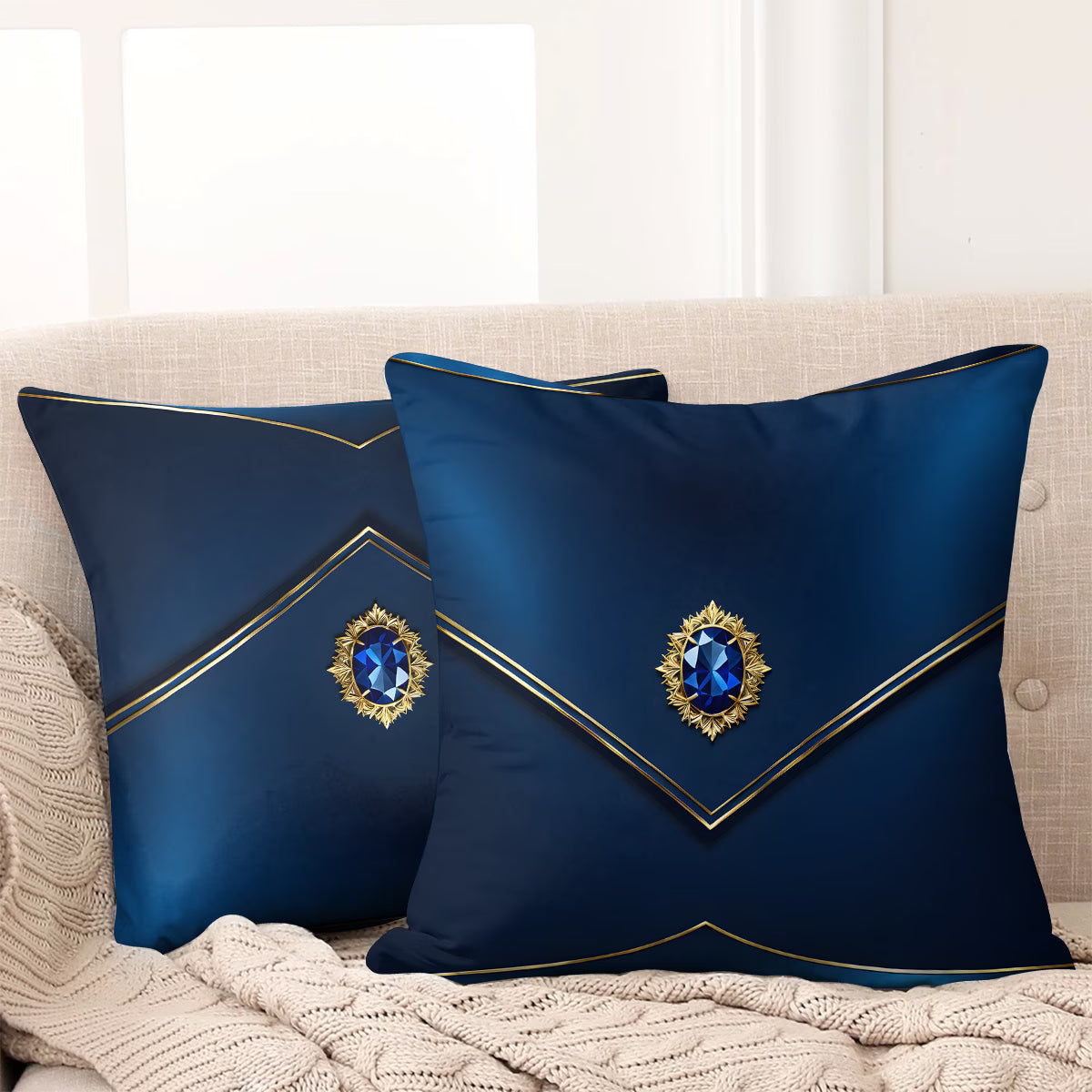 Two decorative blue pillows with gemstone designs on a beige couch.