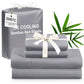 Gray ice cooling bamboo bed sheets with a white ribbon and green leaves on a white background