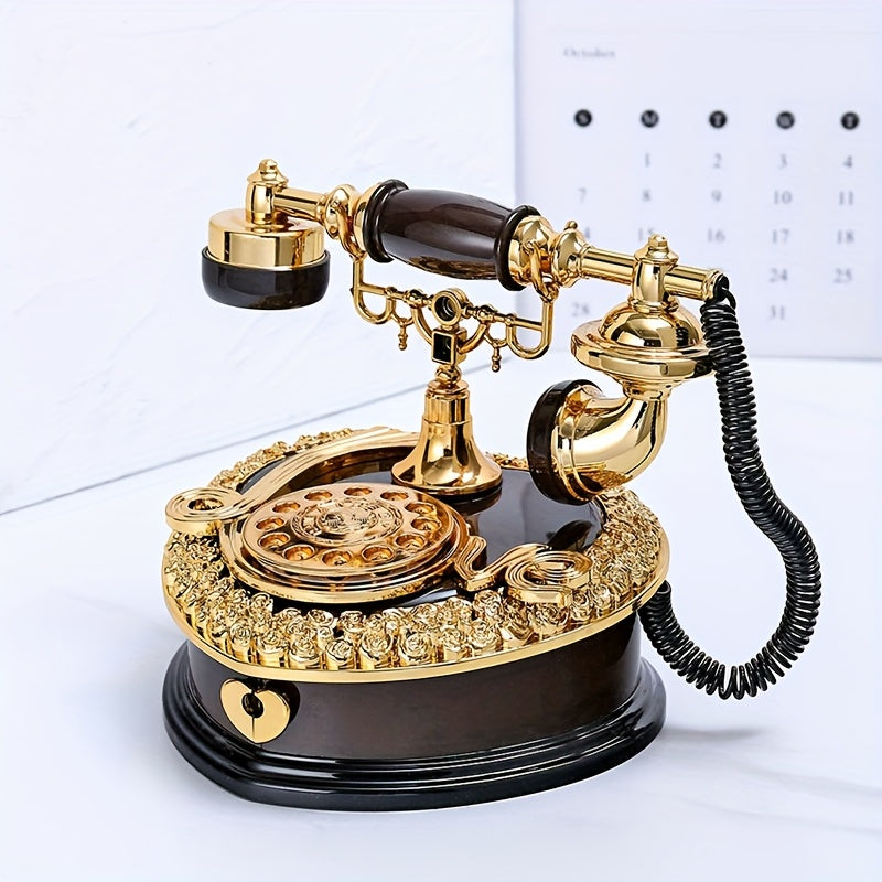 Vintage-style gold and black telephone on a white surface with a calendar in the background.