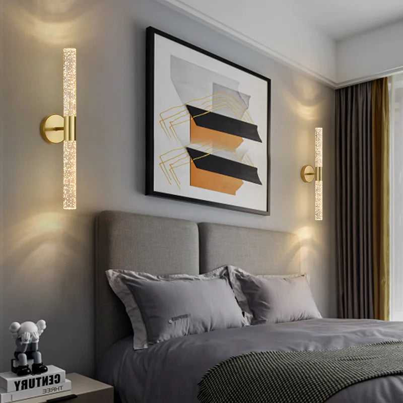 Modern bedroom with gray bedding, abstract art, and wall sconces.