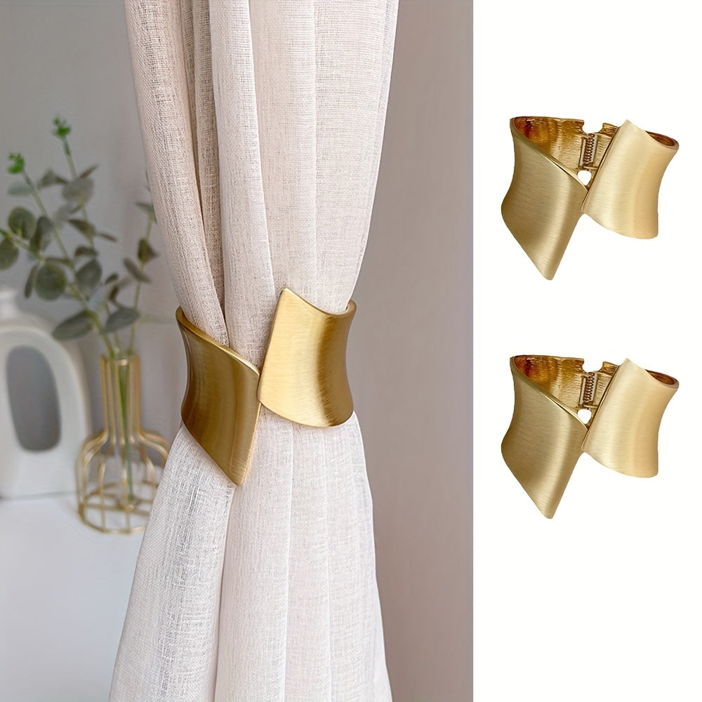Gold curtain tiebacks on a white curtain with a blurred indoor background