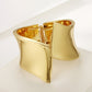Gold bracelet on a white background