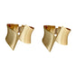 Pair of gold cuff bracelets on a white background