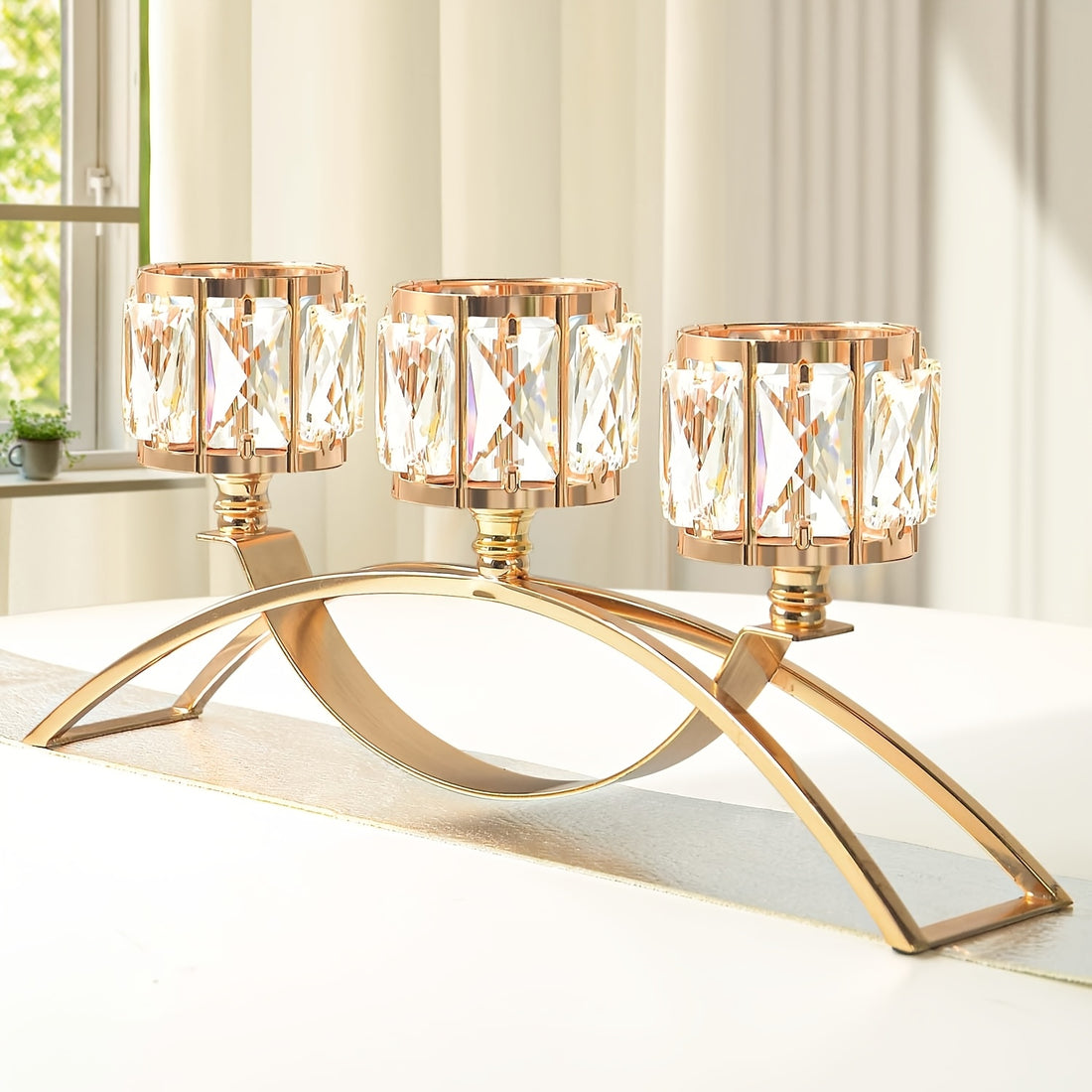 Gold candle holder with crystal-like glass on a white surface