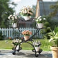 Wrought iron plant stand with multiple potted plants in a garden setting
