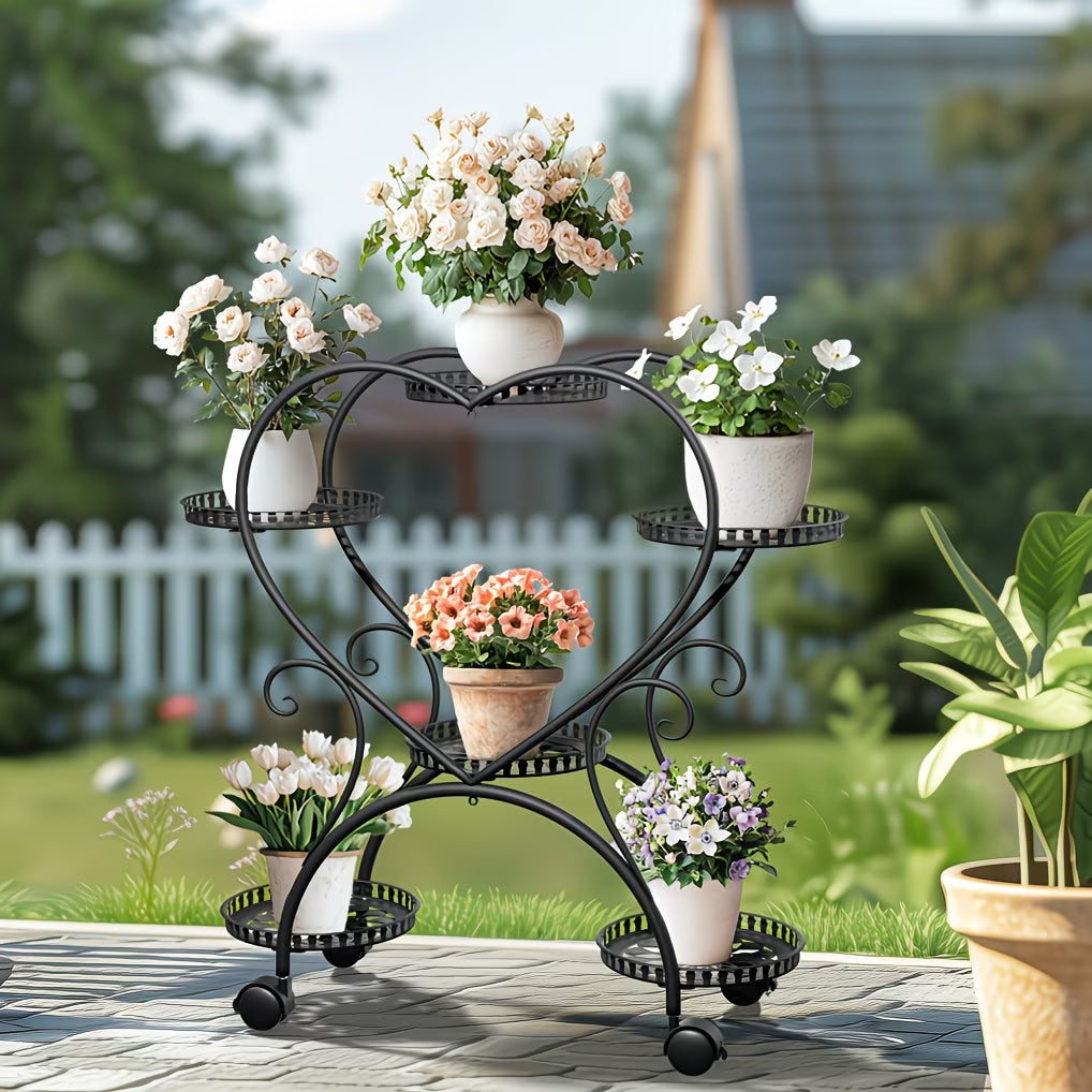 Wrought iron plant stand with multiple potted plants in a garden setting