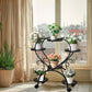Decorative metal plant stand with potted plants in a bright room.