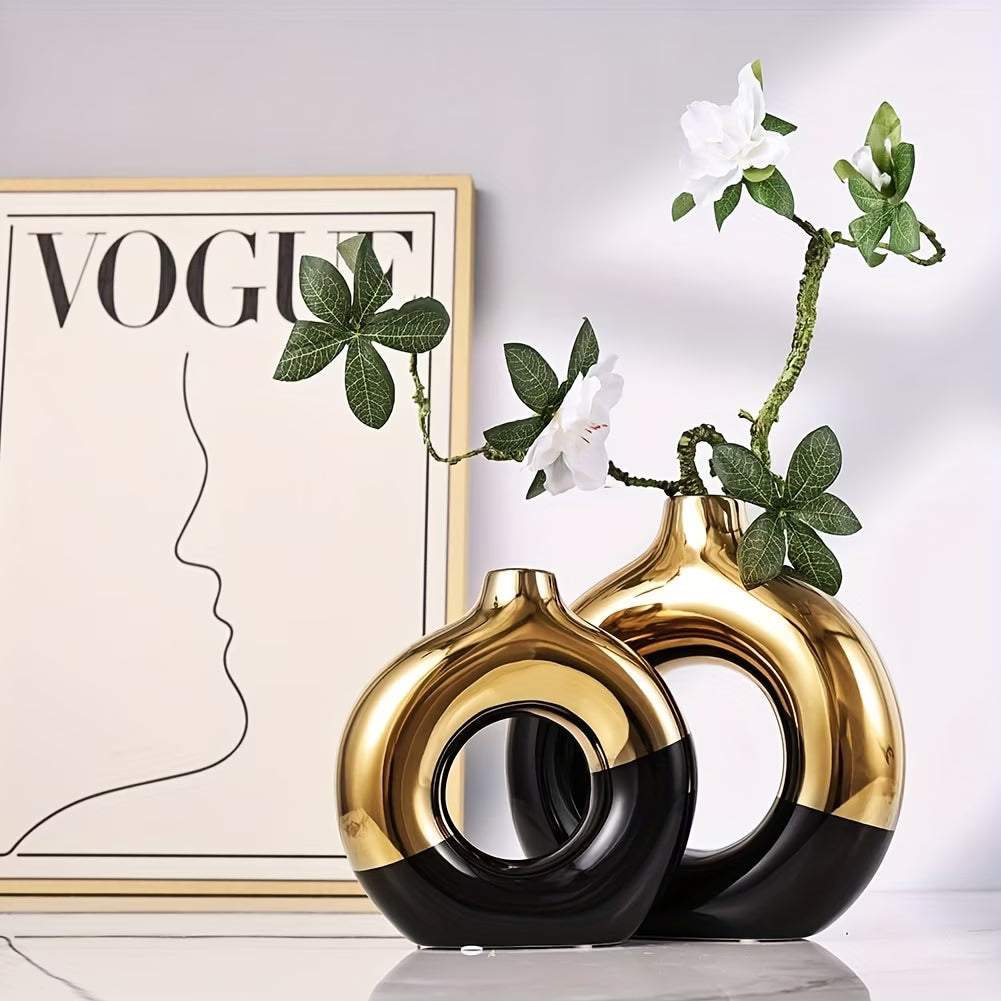 Two black and gold vases with a plant against a Vogue magazine cover background