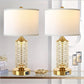 Two decorative table lamps with gold bases and crystal designs on a glass surface.