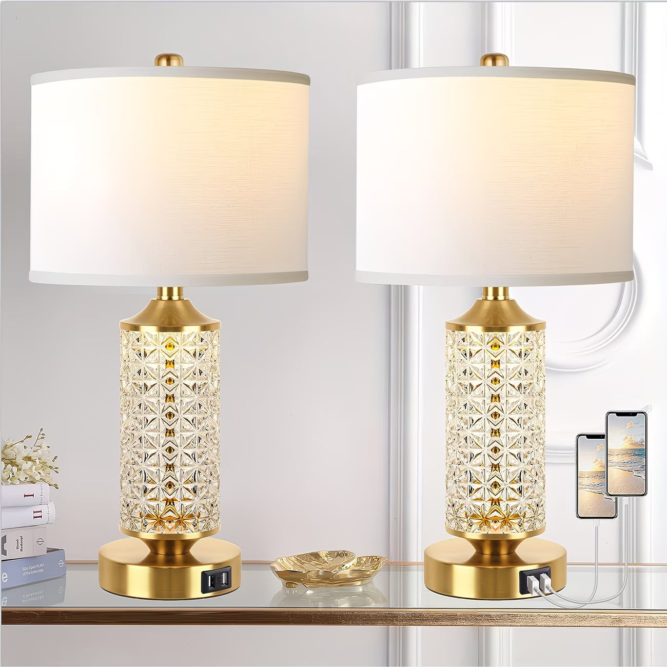 Two table lamps with gold bases and diamond-patterned glass shades on a glass surface.