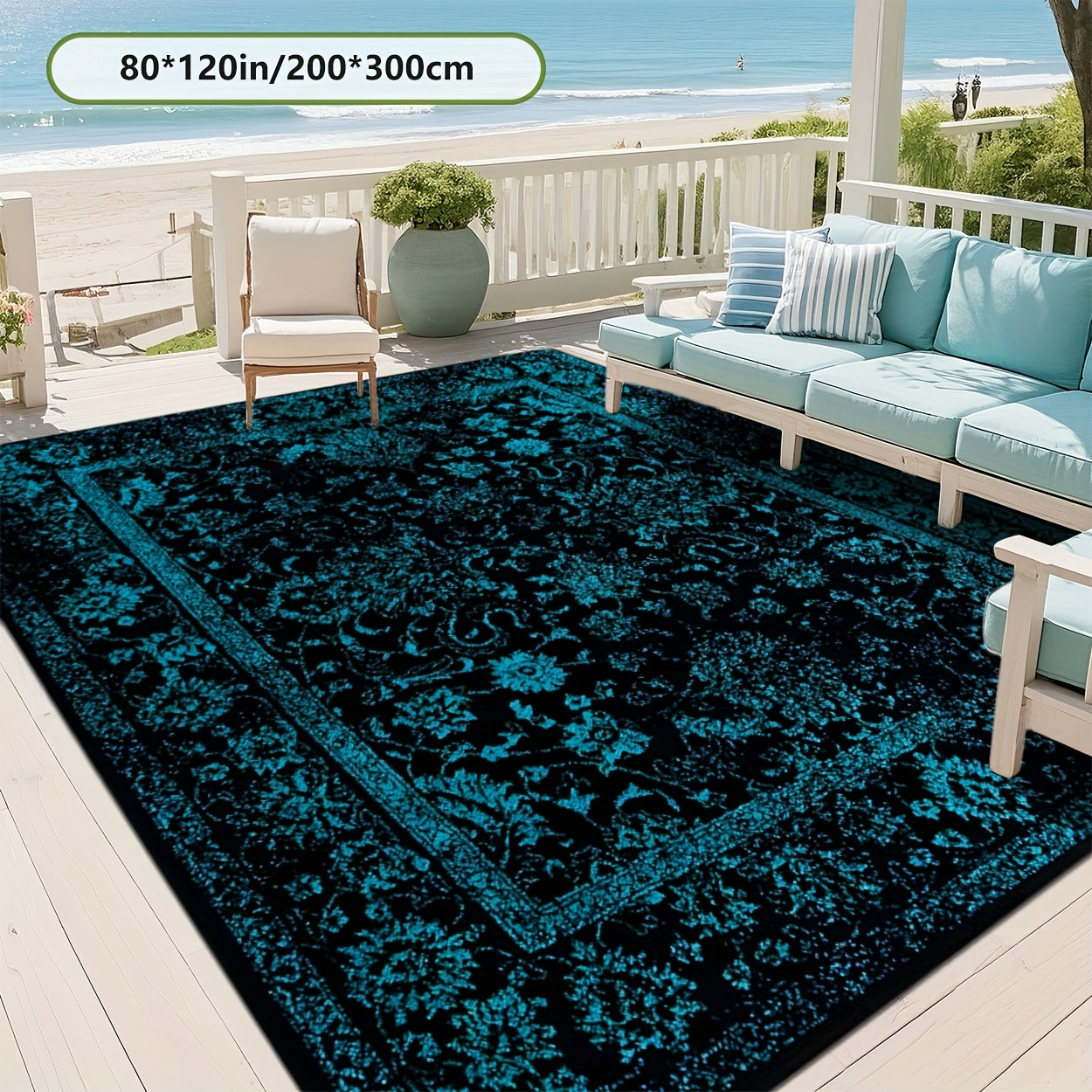 Teal and black patterned rug on a patio with outdoor furniture and ocean view.