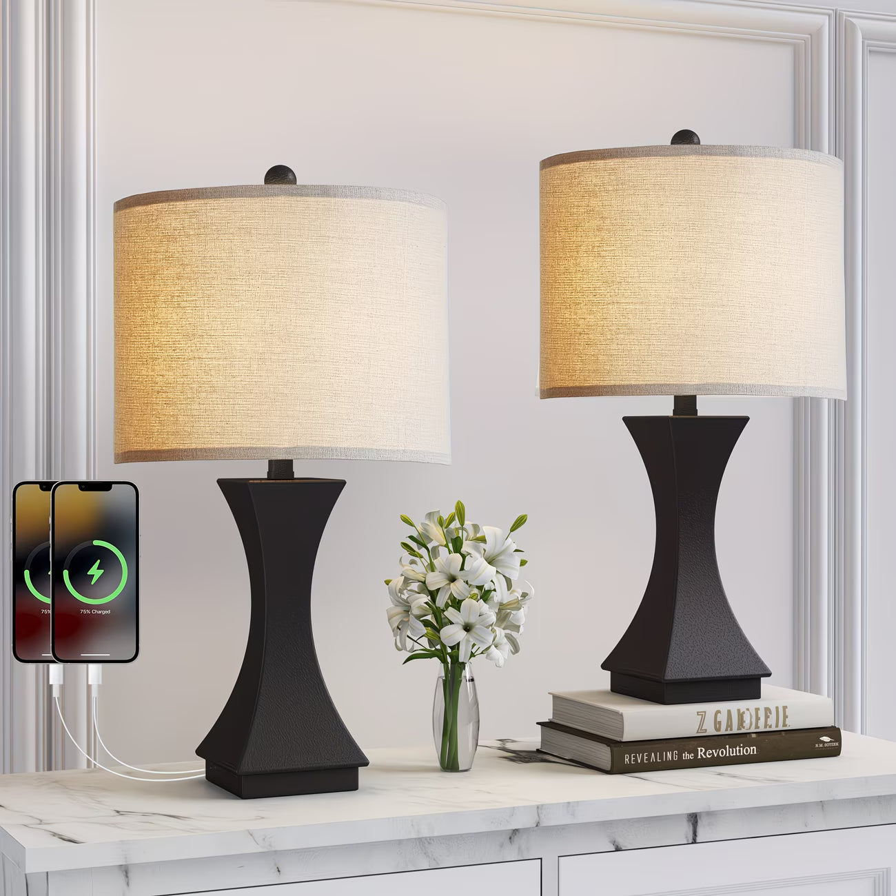 Two black table lamps with beige lampshades on a white surface, with a smartphone displaying charging symbols.