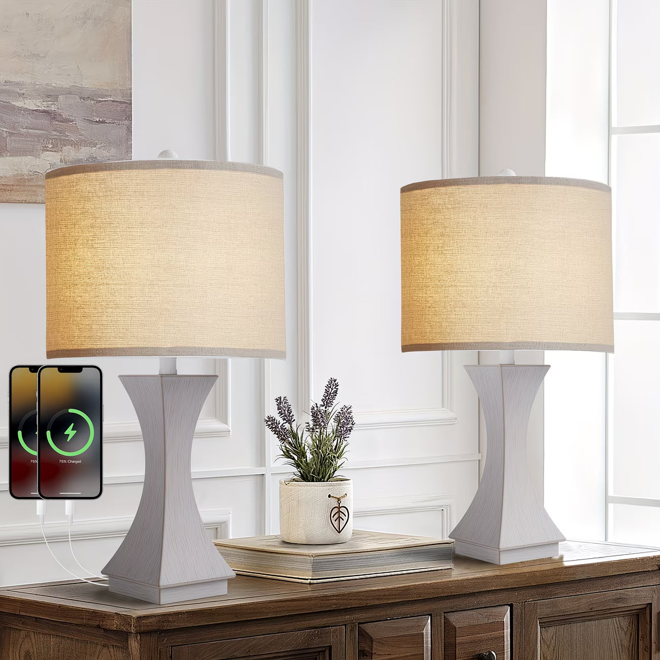 Two table lamps with beige shades on a wooden surface, with a smartphone displaying charging icons.