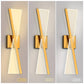 Three wall sconces showing light color temperature effects on a gray background.
