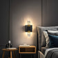 Modern wall sconce lighting fixture in a bedroom setting.