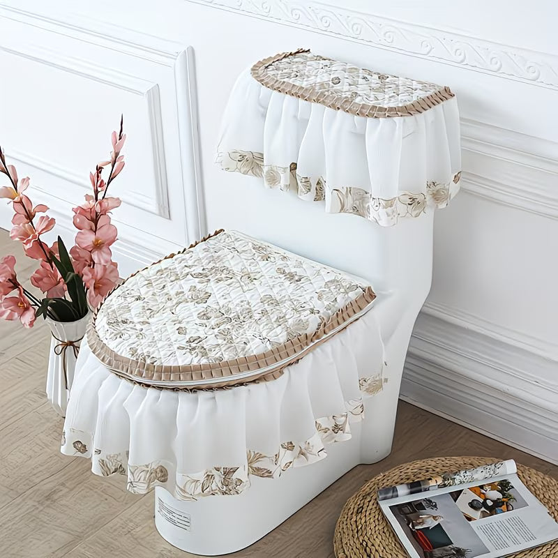 Decorative toilet seat cover set with floral patterns on a white toilet against a white wall.