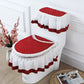 Red and white toilet seat cover set on a toilet against a decorative wall.