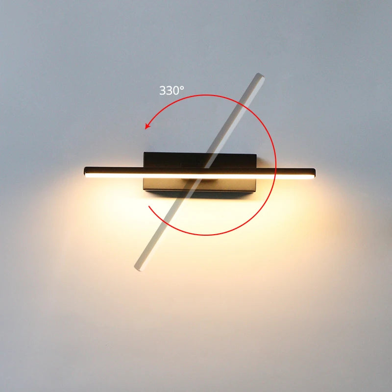 Modern wall-mounted light fixture with a 330-degree rotation feature on a plain wall.