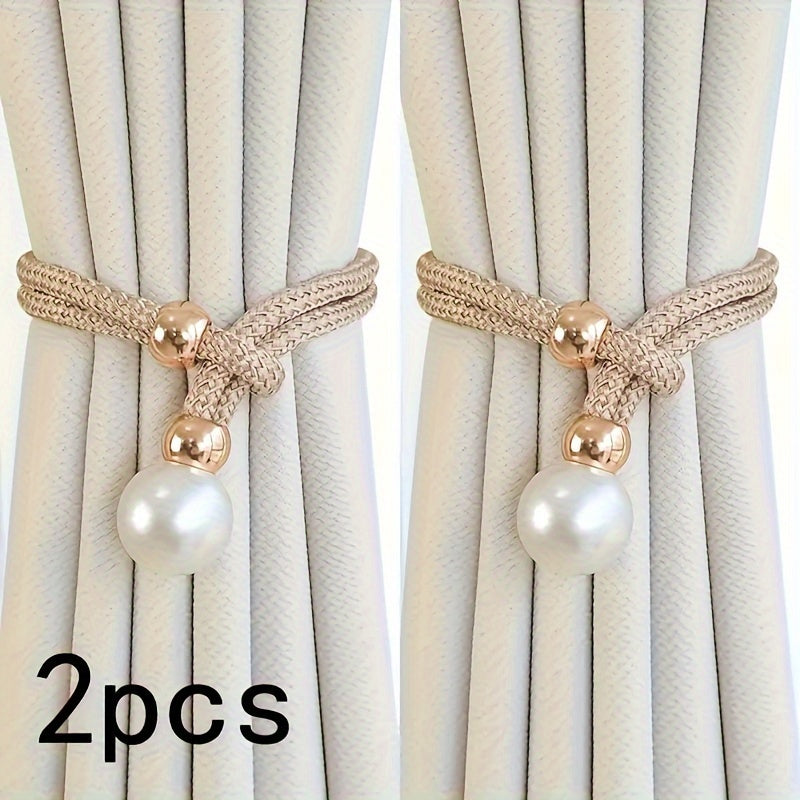Two decorative curtain ties with pearl and gold accents on beige curtains.