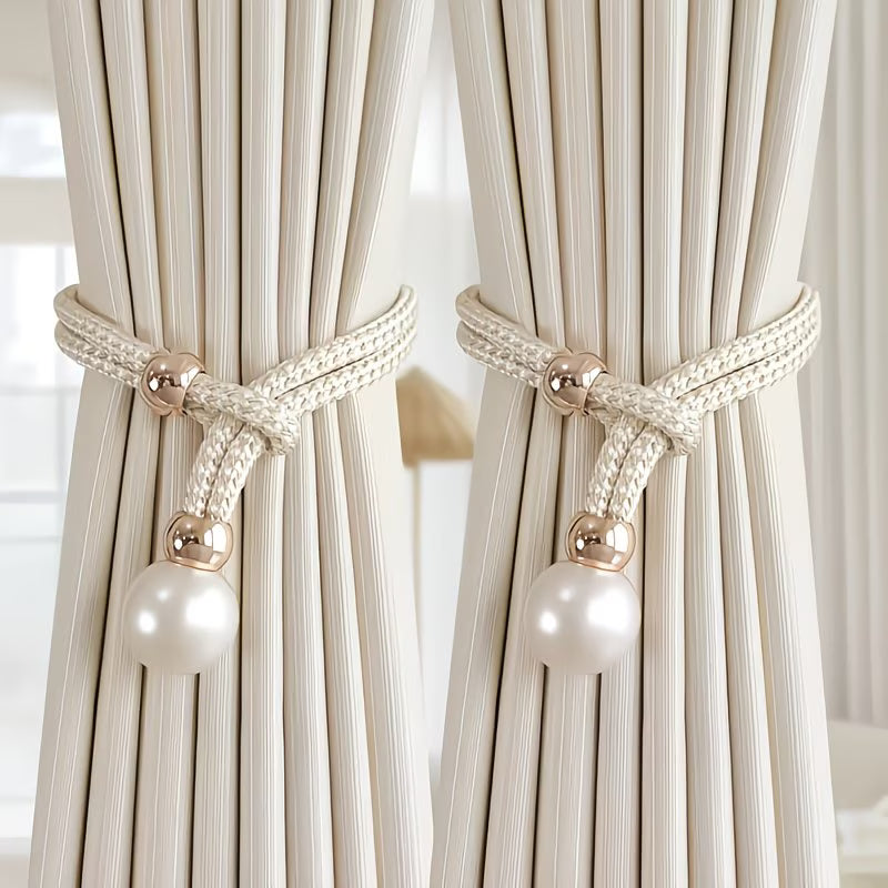 Curtains with decorative tiebacks featuring pearls and gold loops.