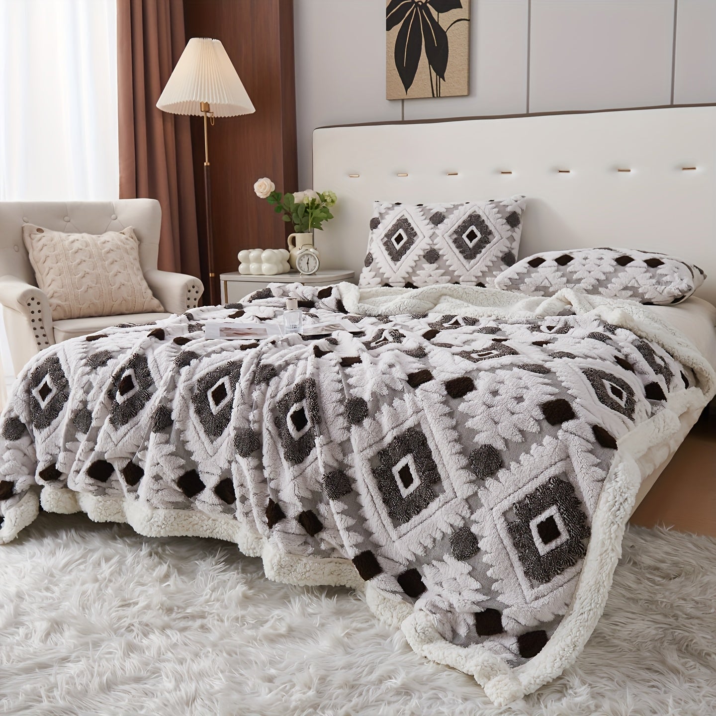 Bed with patterned blanket and pillows in a cozy bedroom setting