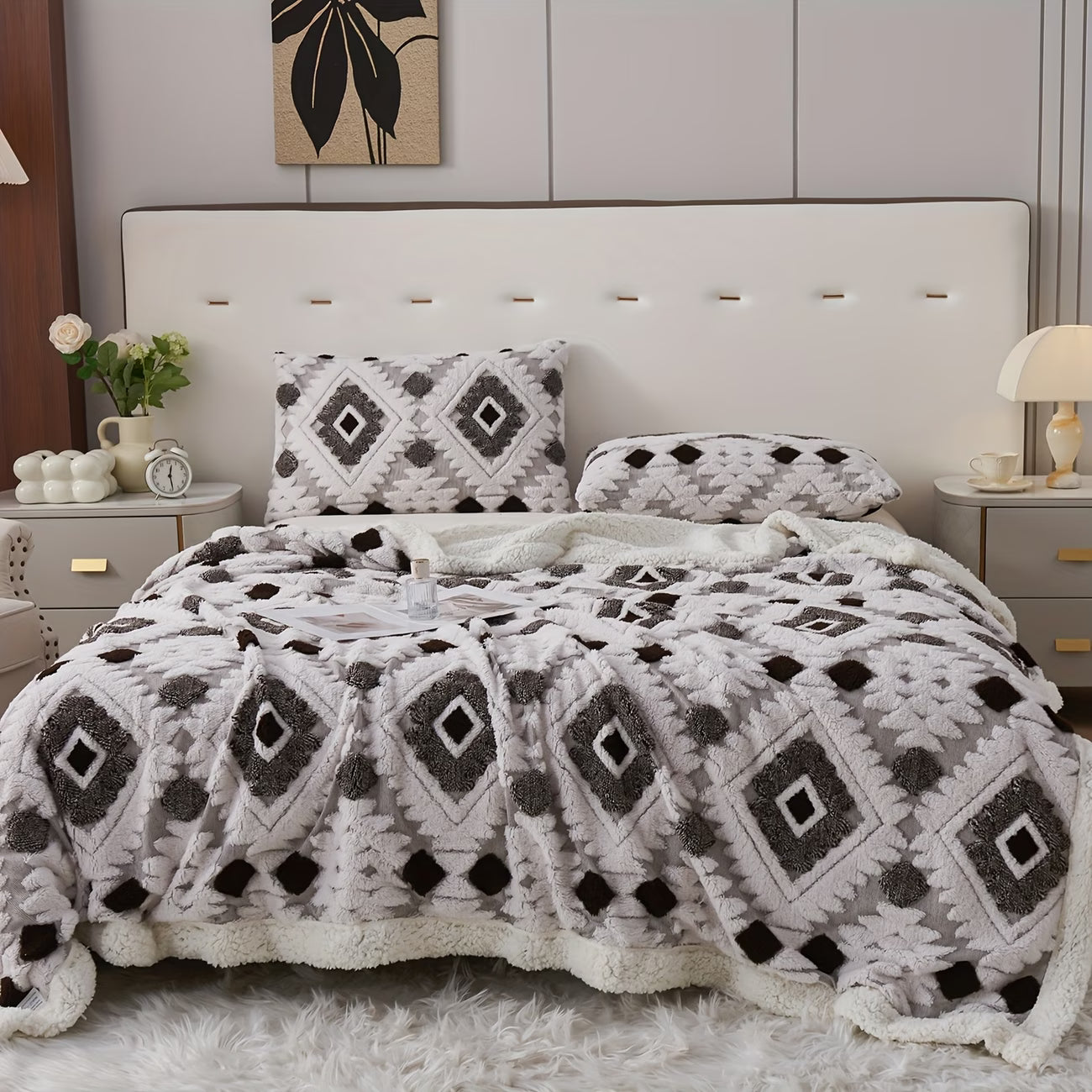 Bedroom with a bed featuring a patterned comforter and pillows.
