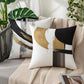 Decorative pillow with abstract design on a couch with plants in the background