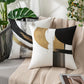 Decorative pillows with abstract patterns on a couch with plants in the background