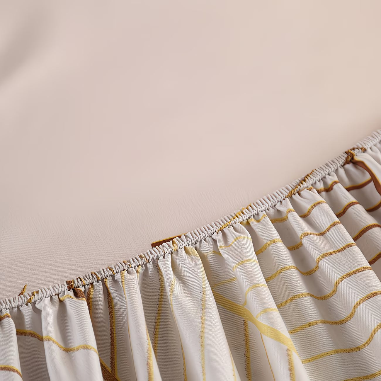 Close-up of a curtain with gold wave patterns on a plain background