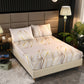 Bed with leaf-patterned bedding in a bedroom setting