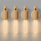 Four wooden wall lights with a warm glow on a gray background