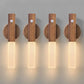Wooden wall sconce with a light fixture on a plain background