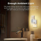 Bathroom scene with a night light on the wall, emitting soft light.