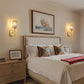 Neatly made bed with decorative pillows in a bedroom setting.
