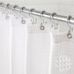 Shower curtain with hooks attached to a rod against a tiled wall.