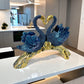 Decorative sculpture of two swans on a branch in a modern kitchen.