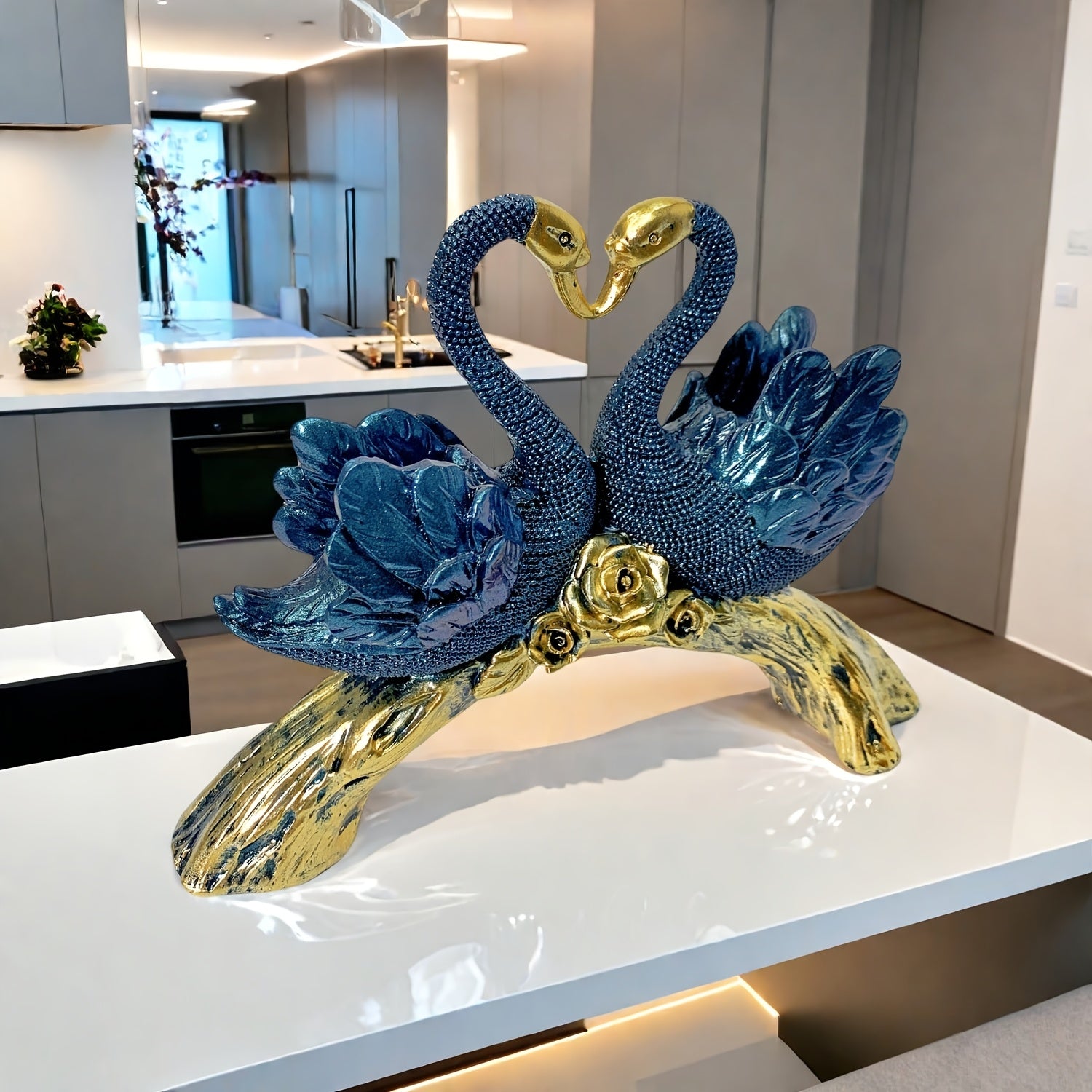Decorative sculpture of two swans on a branch in a modern kitchen.