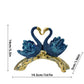 Decorative sculpture of two swans on a branch with measurements indicated.