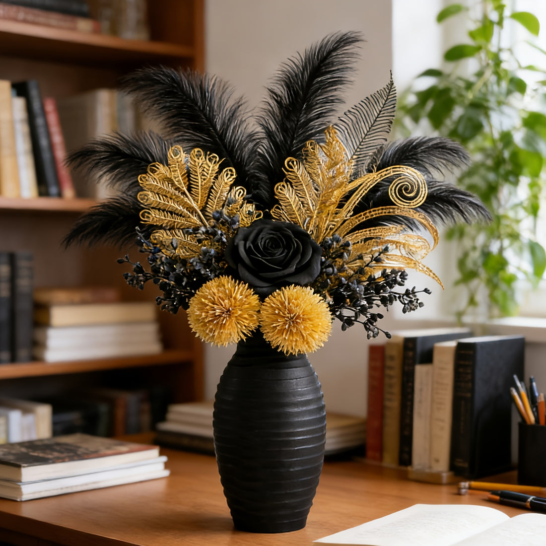 Decorative floral arrangement with black and gold flowers in a black vase on a desk.