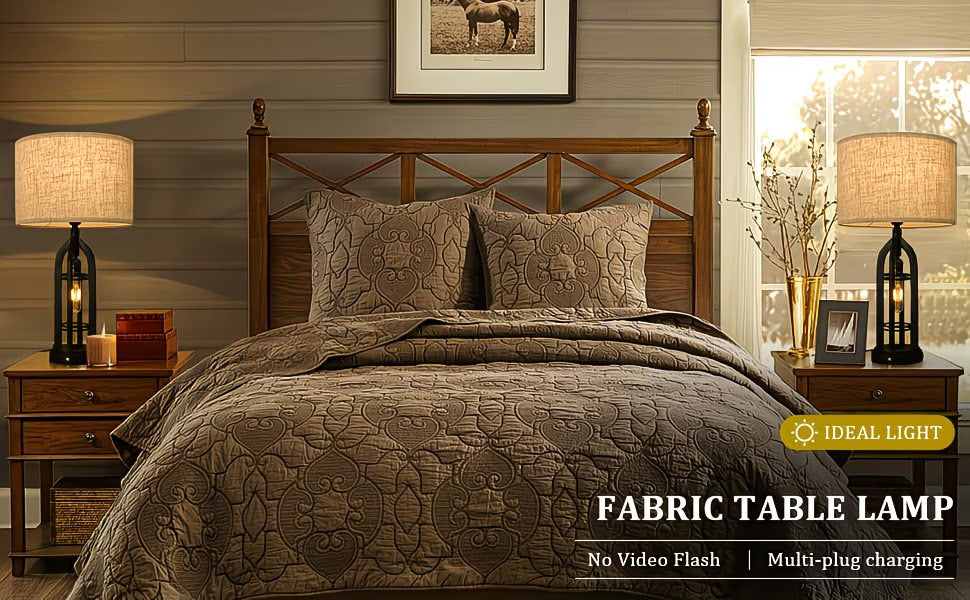 Bedroom with wooden headboard, patterned bedding, and fabric table lamps on nightstands.