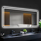 Bathroom with a large illuminated mirror above a sink