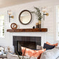 Living room with a fireplace, mirror, and decorative pillows.