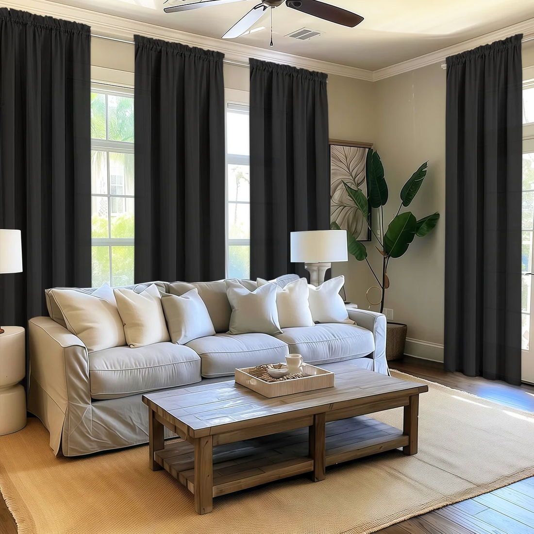 Living room with a beige sectional sofa, wooden coffee table, and dark curtains.
