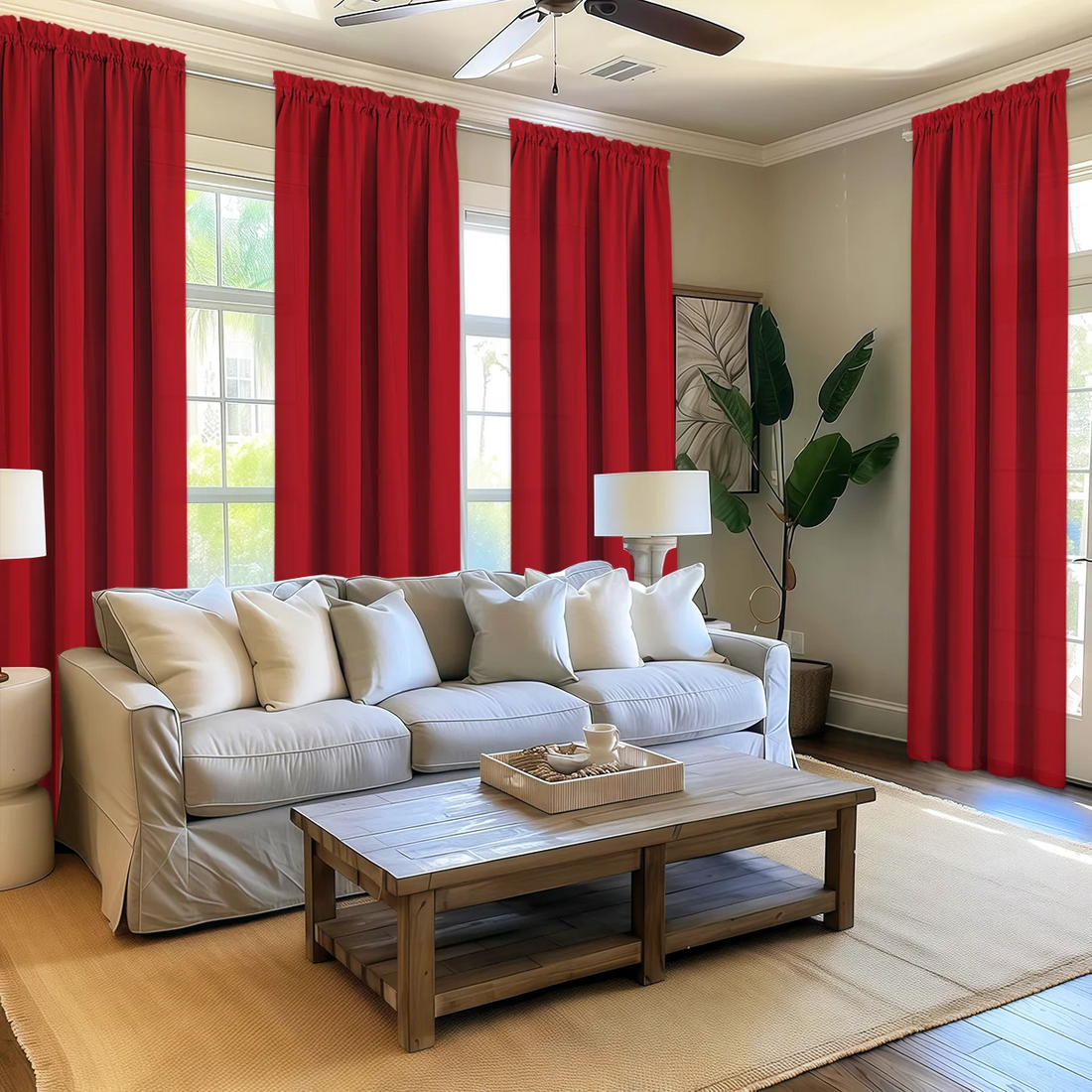 Living room with red curtains, beige sofa, wooden coffee table, and decorative items.