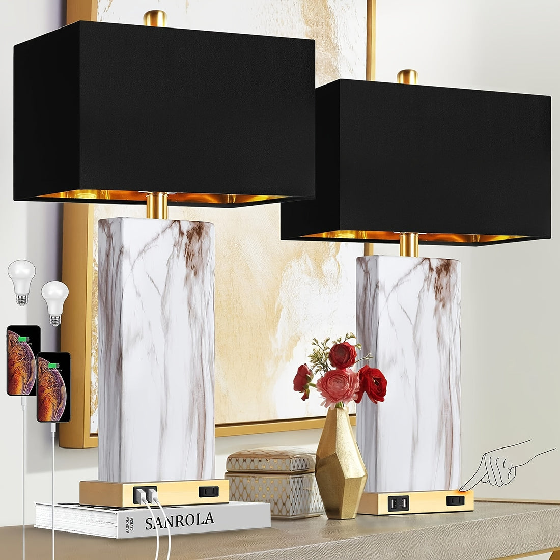 Two black table lamps with gold bases on a decorative shelf.